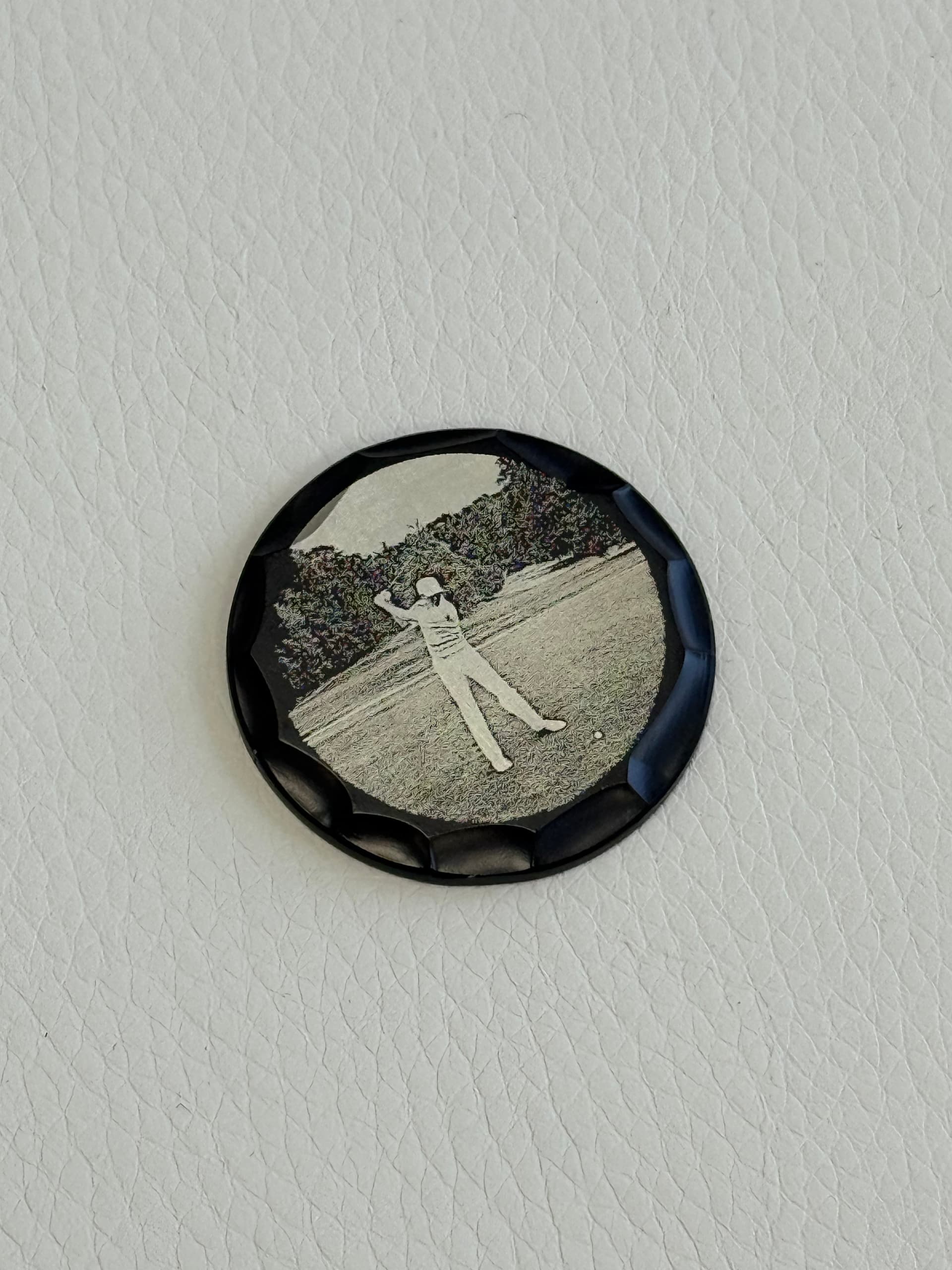 Photo engraved golf ball marker showing a golfer mid-swing