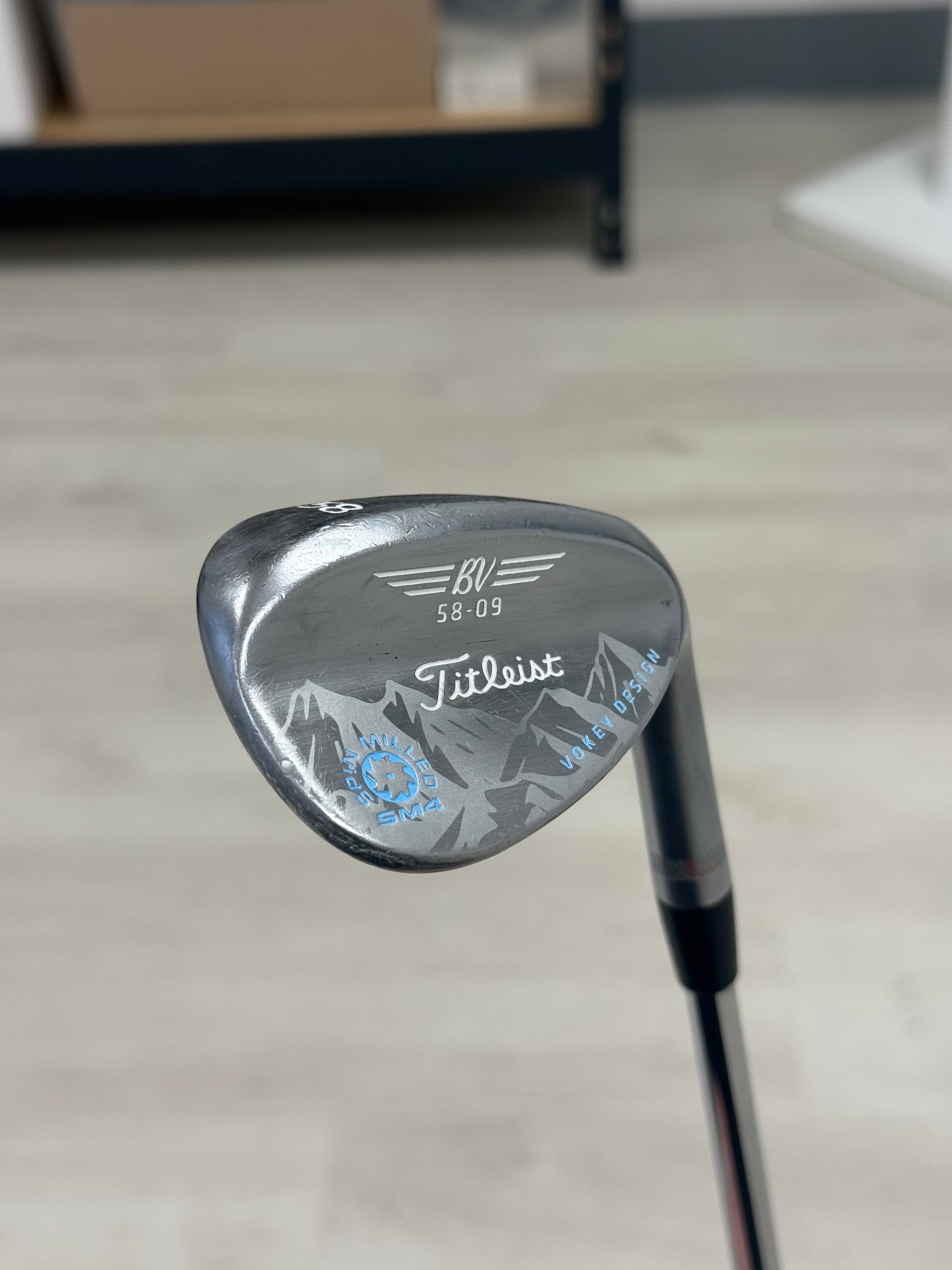 Titleist Vokey 58-09 wedge with mountain range engraving and blue accents