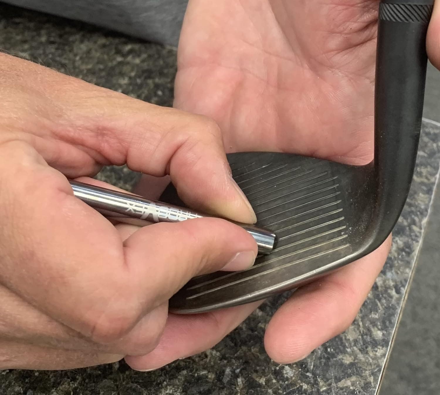 GrooVex sharpening the grooves on a golf wedge